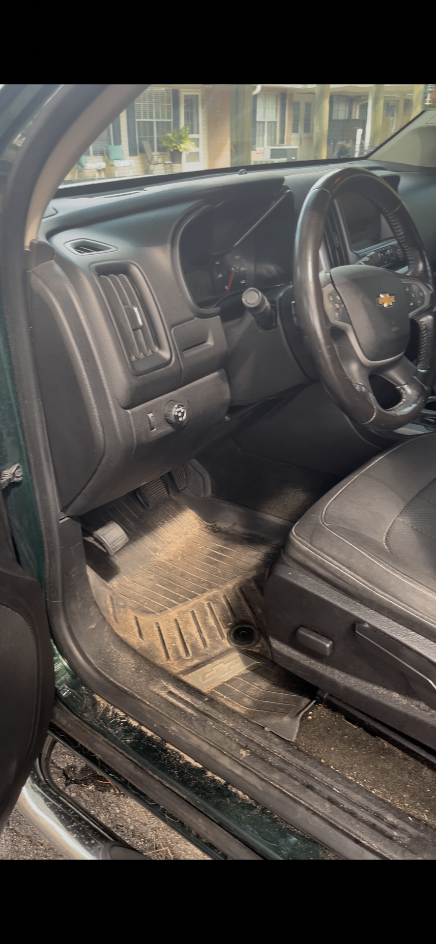 Chevy Colorado driver-side floor covered in sand and debris before mobile interior detail in Citrus County FL